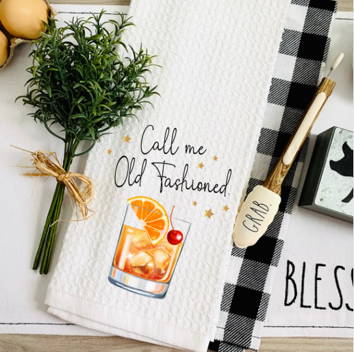 Call Me Old Fashioned waffle weave towel displayed on bar counter with whiskey glass