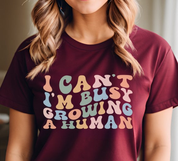 Funny pregnancy reveal shirt with I Can’t I’m Busy Growing a Human words