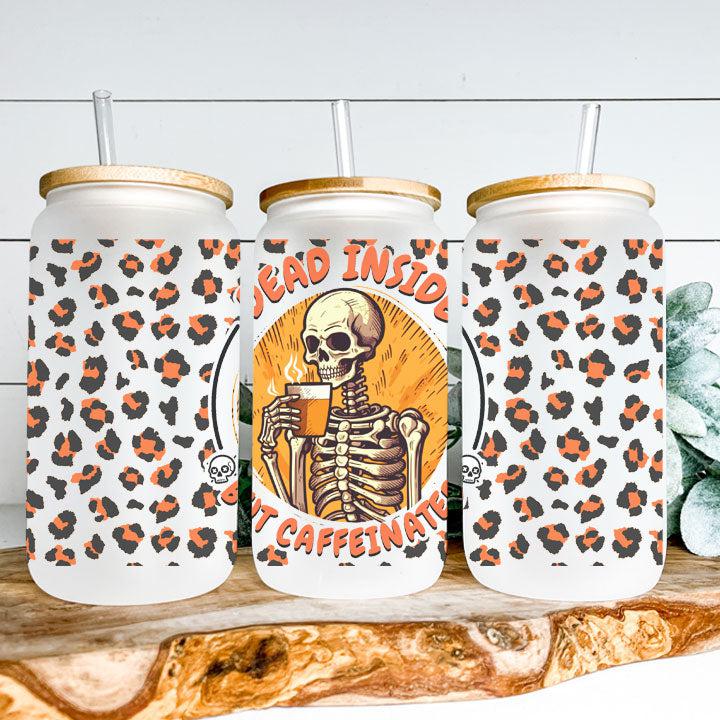 Reusable iced coffee tumbler featuring skeleton and humorous “Dead Inside But Caffeinated” phrase, fun spooky gift.