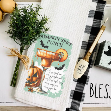 Close-up of Halloween cocktail recipe print on waffle weave towel