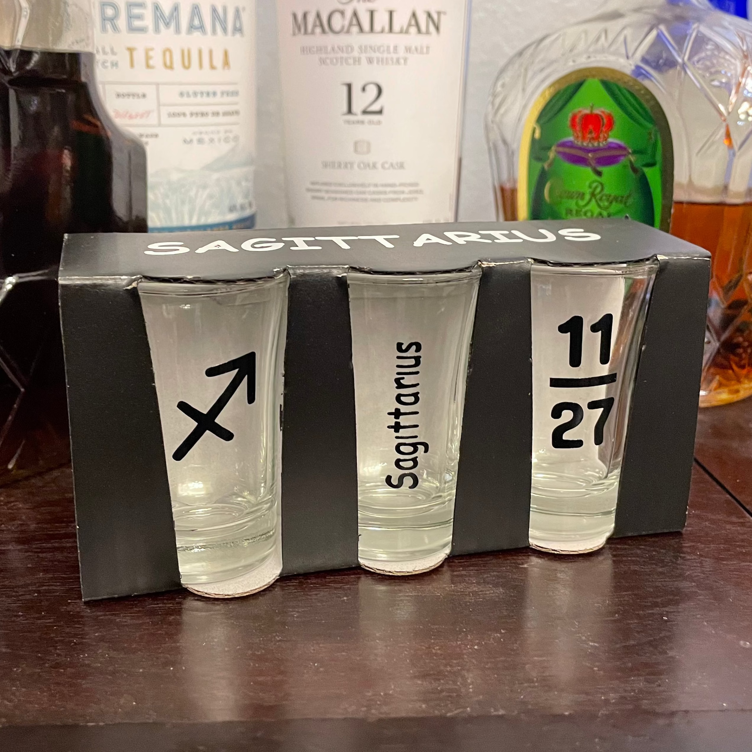 Personalized birthday shot glass set displaying zodiac symbol, zodiac name, and birth date