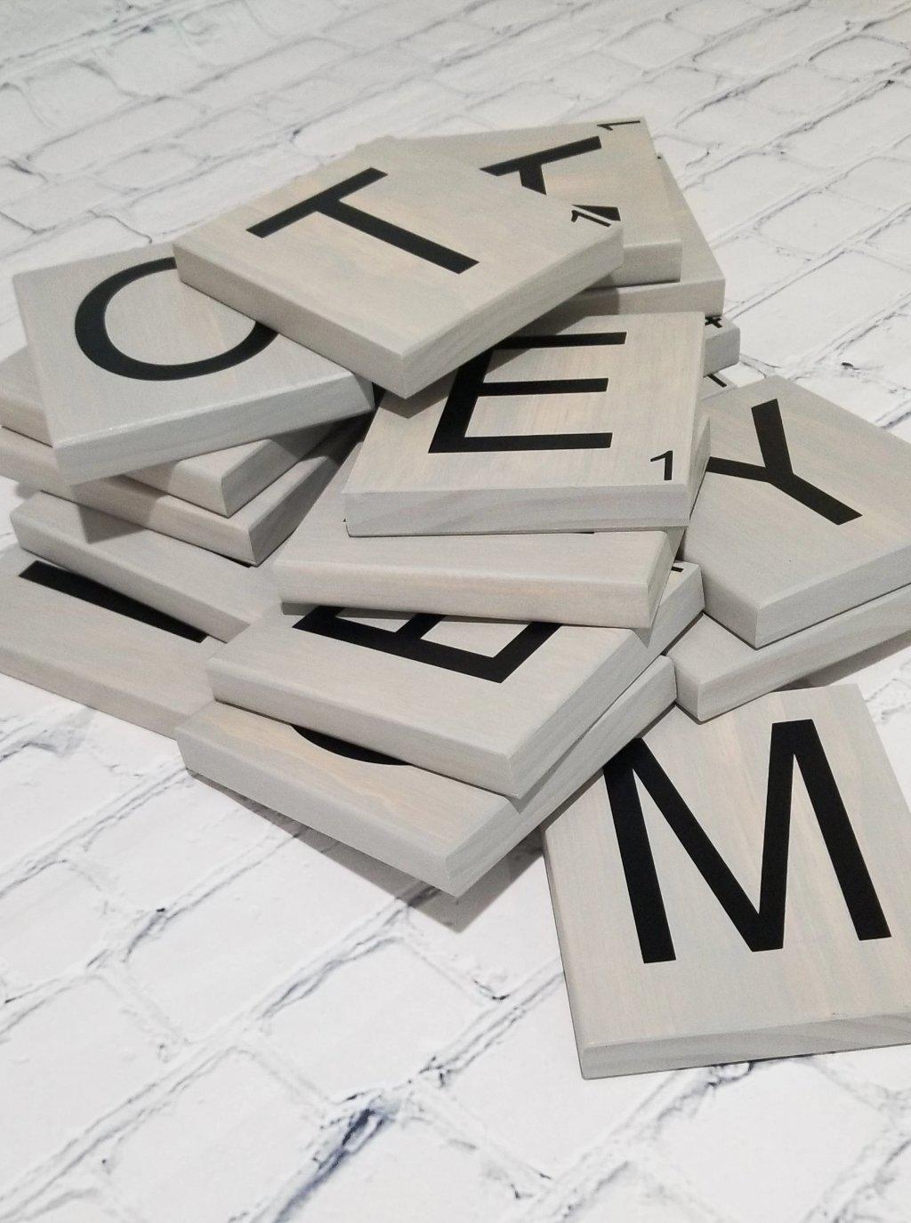 Coastal home décor featuring large oak Scrabble tiles spelling ocean words.