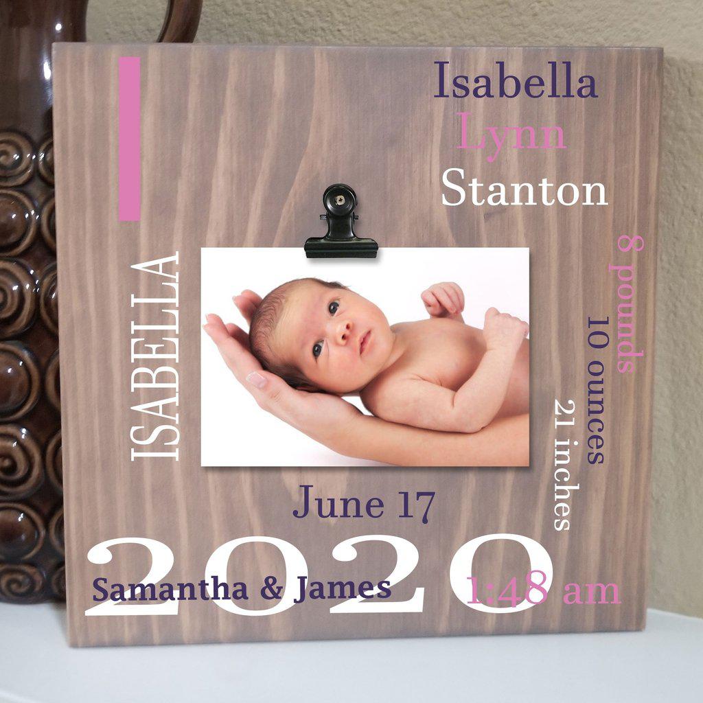 Custom engraved wooden sign with baby birth details displayed in a nursery