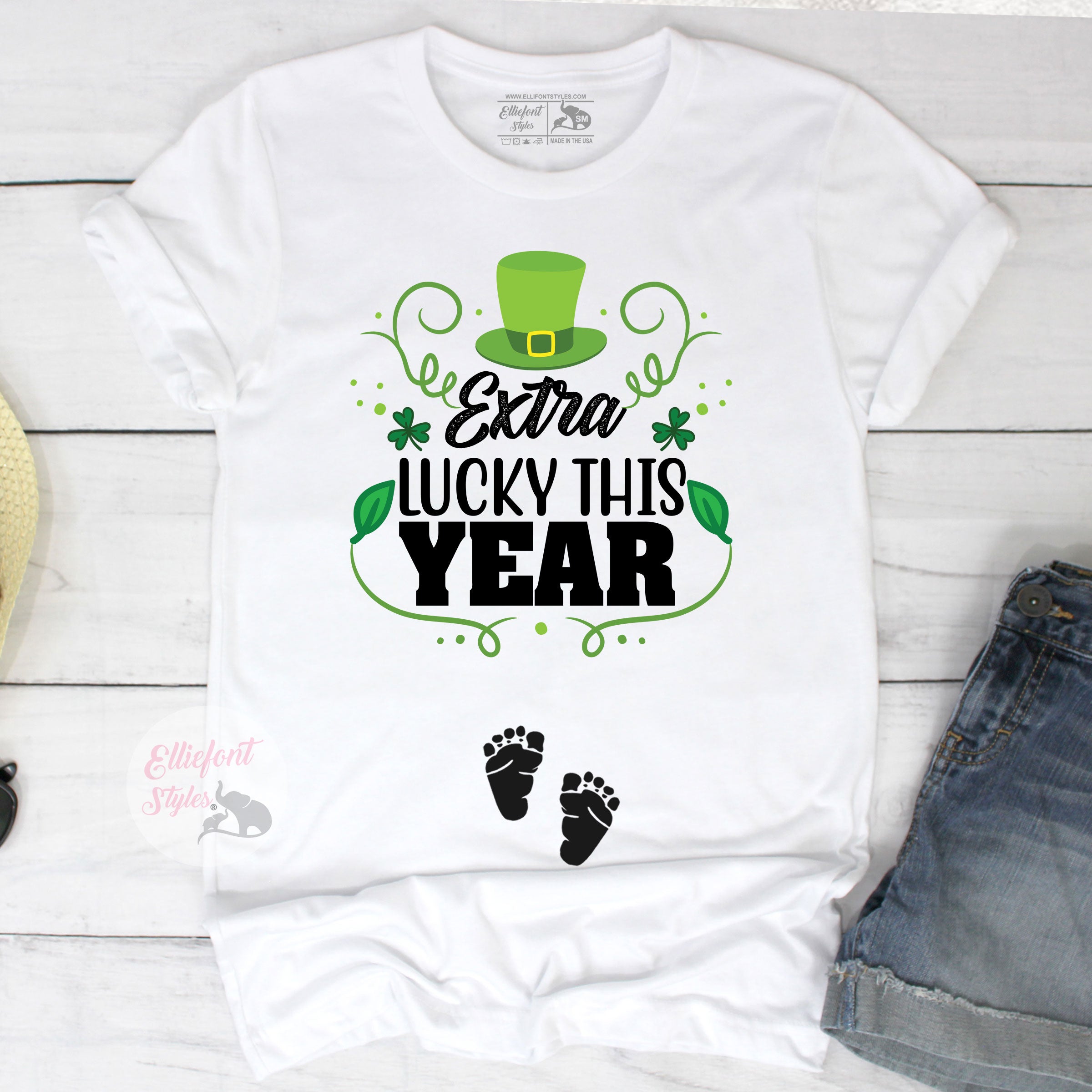 Extra Lucky This Year pregnancy announcement shirt with St. Patrick’s Day hat and clovers