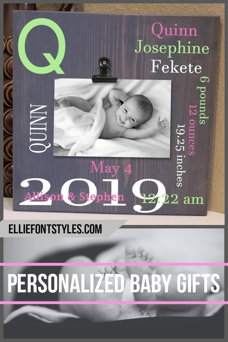 Wooden baby birth stats sign with photo clip holding a newborn family picture