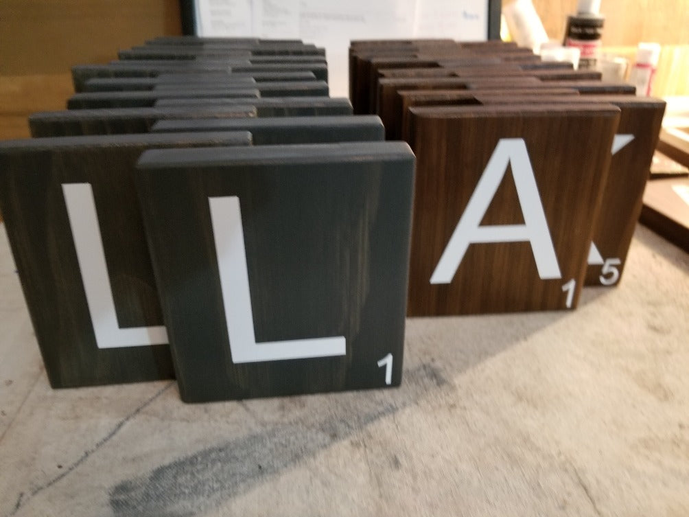 Oversized Scrabble tiles made of wood for home decoration.