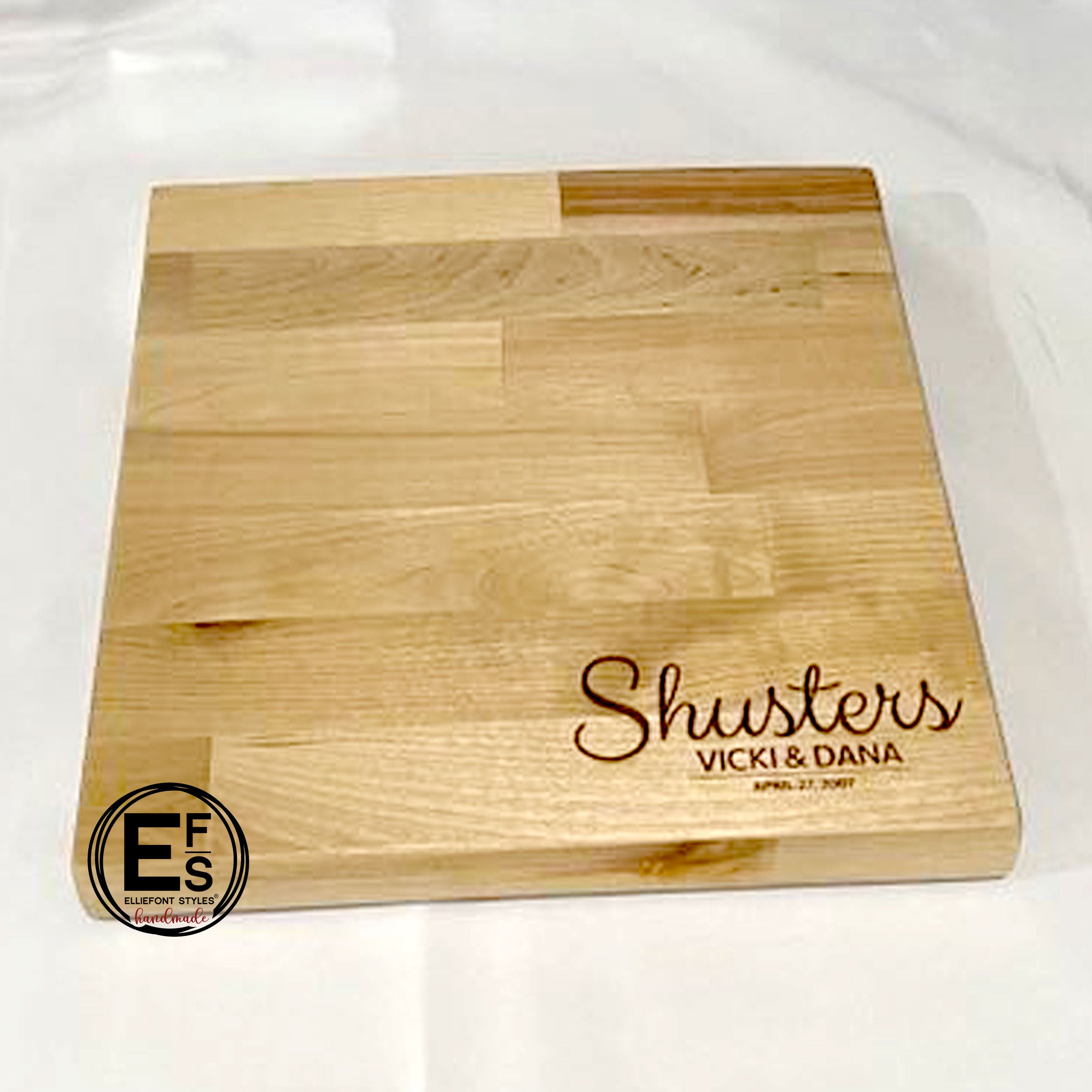 Personalized cutting board engraved with family name and couple names for wedding gift