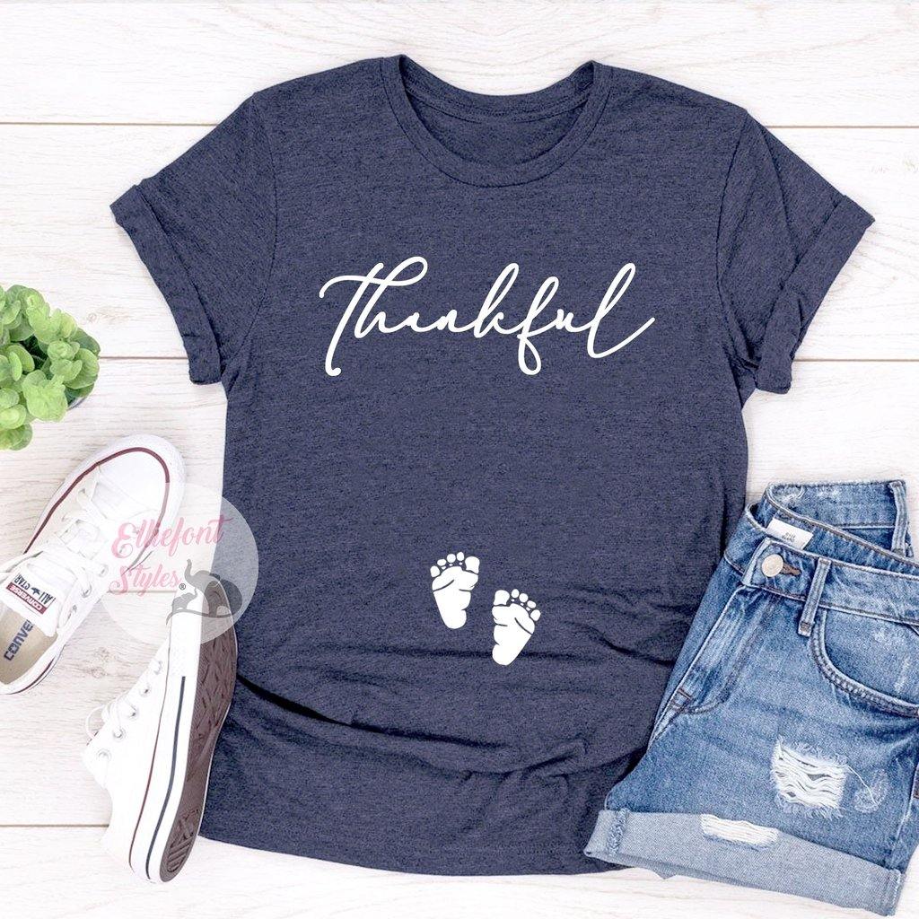 Thanksgiving pregnancy reveal shirt for women with Thankful text and footprints