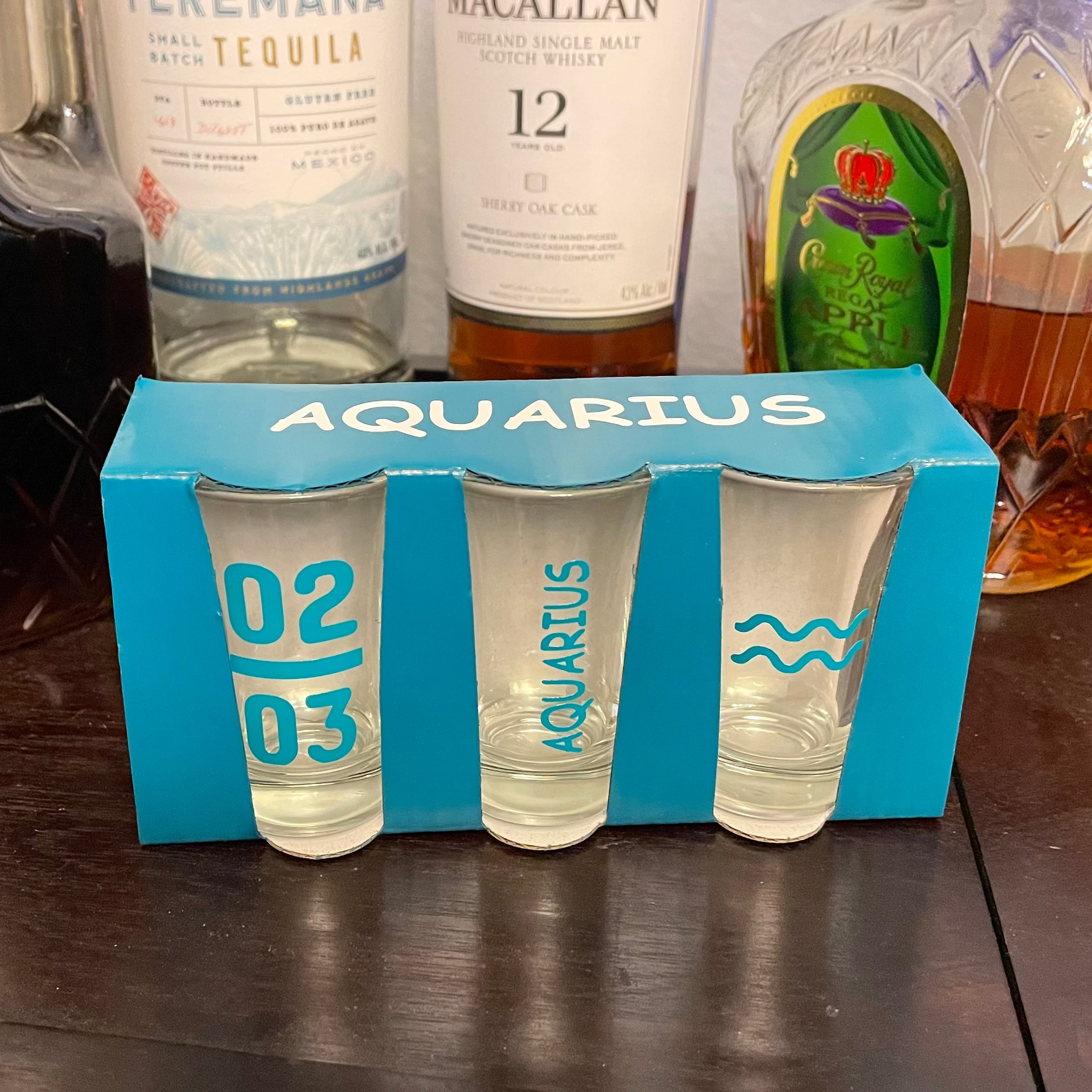 Set of three astrology-themed personalized shot glasses arranged together