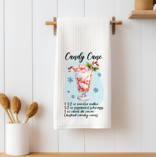 Candy Cane Martini recipe towel displayed with Christmas drink accessories