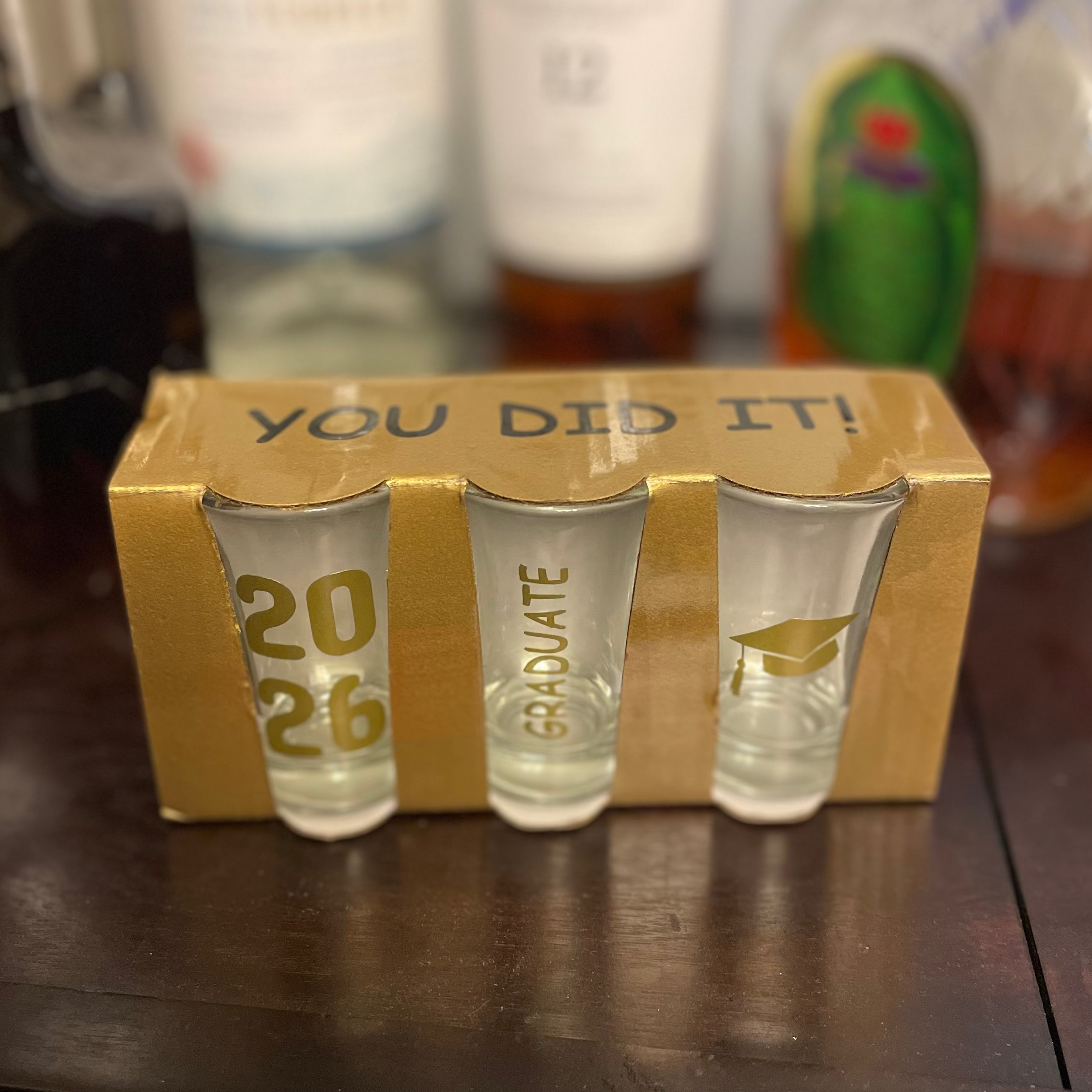 Personalized graduation shot glasses displayed as party keepsake gifts