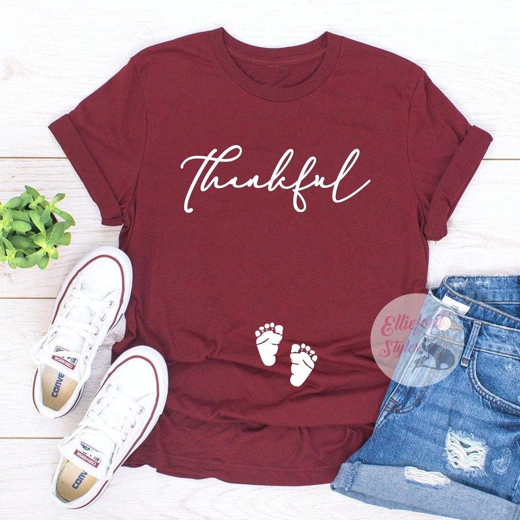 Fall baby announcement shirt with Thankful text and footprints on the belly