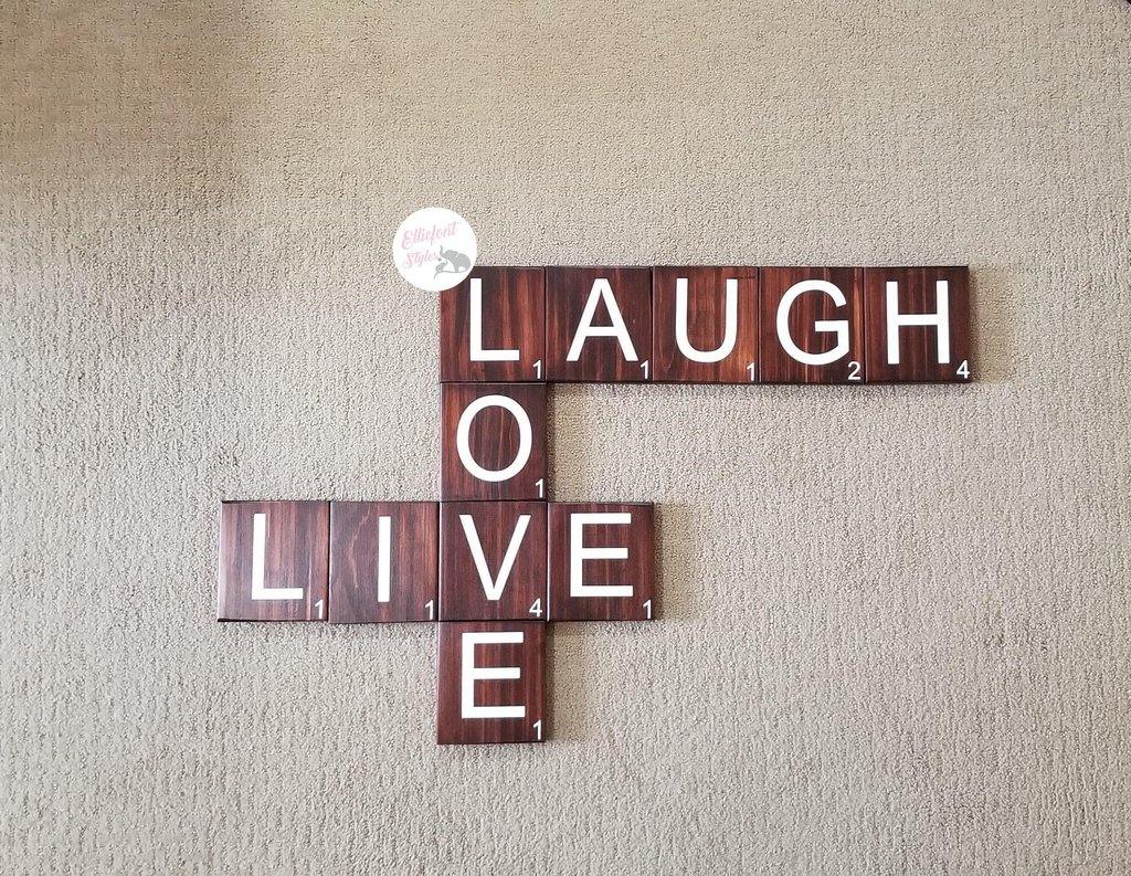 Large wood Scrabble tiles spelling Live Laugh Love for wall décor.
