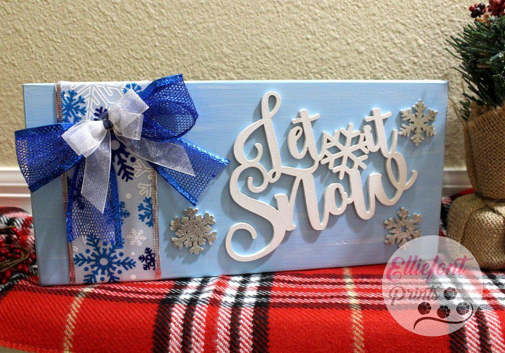 Solid oak holiday sign with Let It Snow text in blue, silver, and white.