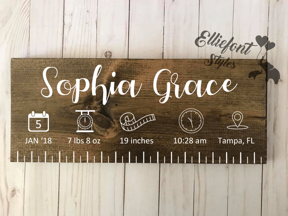 Wooden birth ruler sign styled as nursery wall décor for baby room