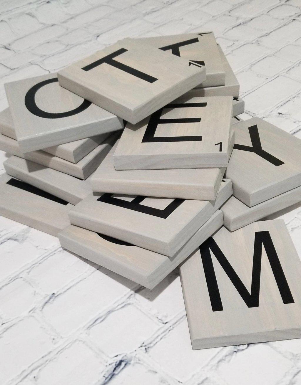 Oversized wooden Scrabble letters used for family wall decoration.