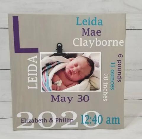 Wooden baby birth stats sign with photo clip displaying newborn picture